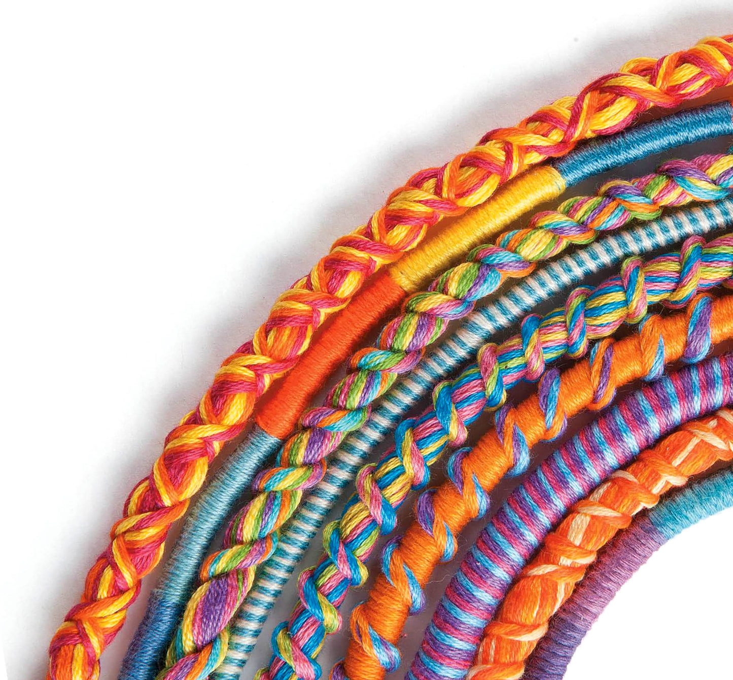 Six vibrant friendship bracelets from Leisure Arts’ “Amazing Jewelry Made Easy” collection, each featuring unique weaving and braiding techniques, are arranged in a semi-circle on a white background. Showcasing bright rainbow colors and assorted textures, these playful accessories celebrate the creativity and fun of DIY bracelet making.
