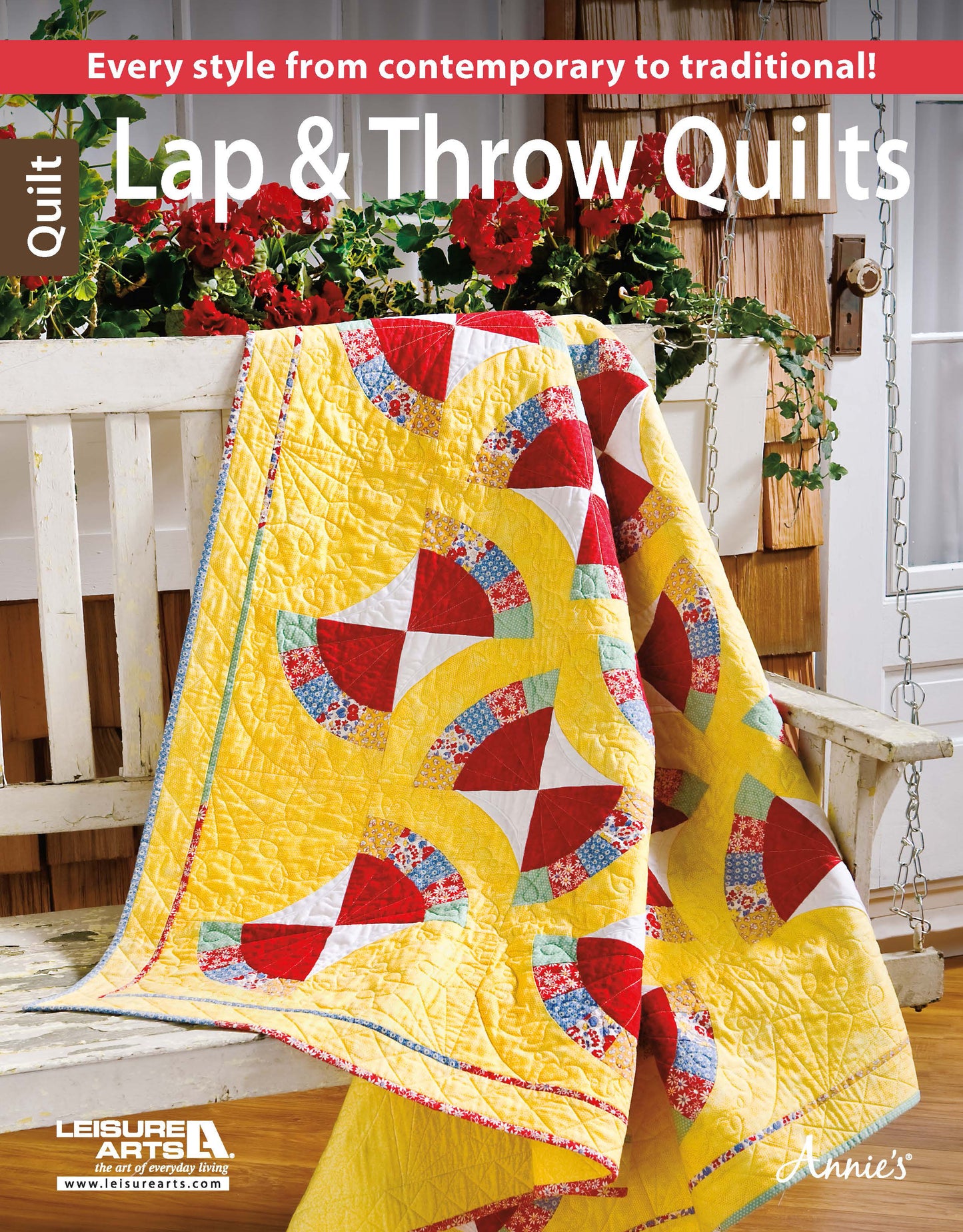 A vibrant quilt from Leisure Arts' Lap & Throw Quilts collection featuring a yellow background with red, white, and floral patterns is draped over a white bench with potted plants—ideal for beginner quilting projects and all occasions.