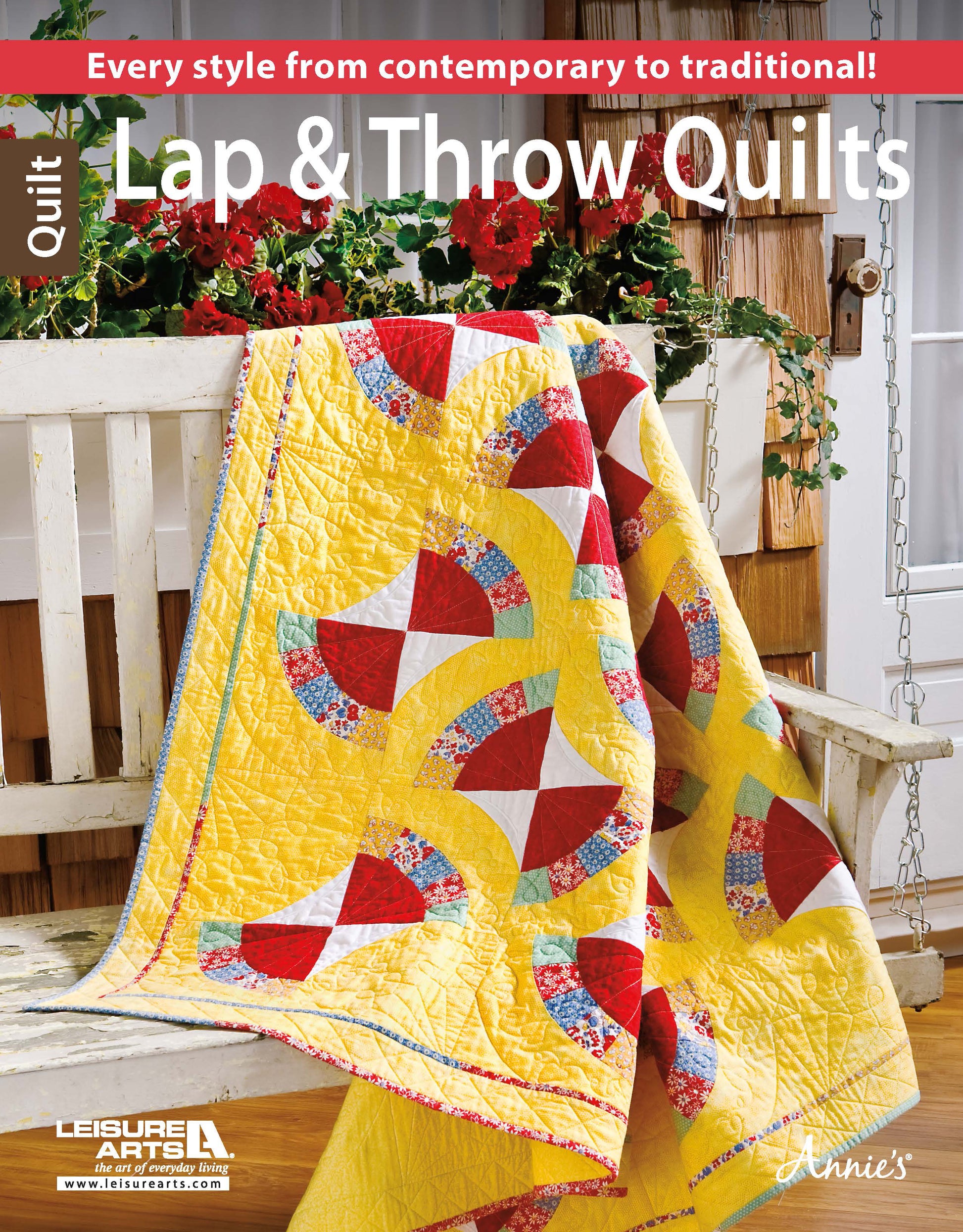 A vibrant quilt from Leisure Arts' Lap & Throw Quilts collection featuring a yellow background with red, white, and floral patterns is draped over a white bench with potted plants—ideal for beginner quilting projects and all occasions.