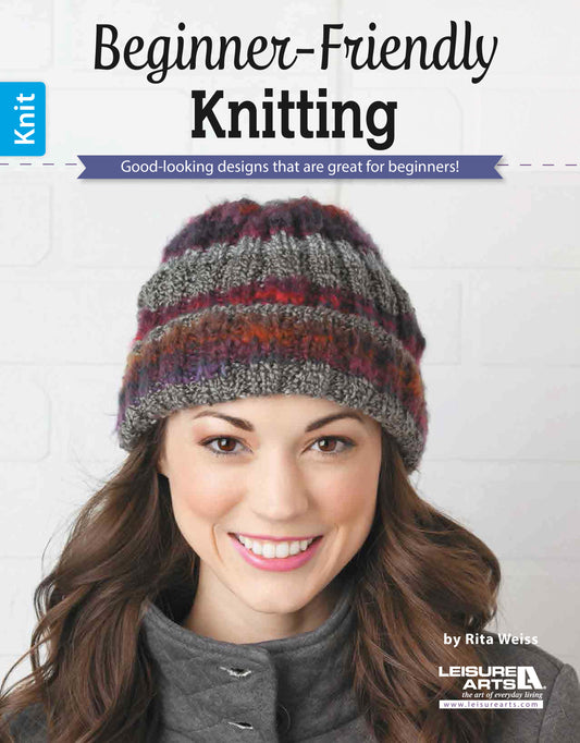 A smiling woman in a colorful knit hat and gray coat appears on the cover of "Beginner-Friendly Knitting" by Leisure Arts, featuring easy patterns and stylish designs perfect for beginners.