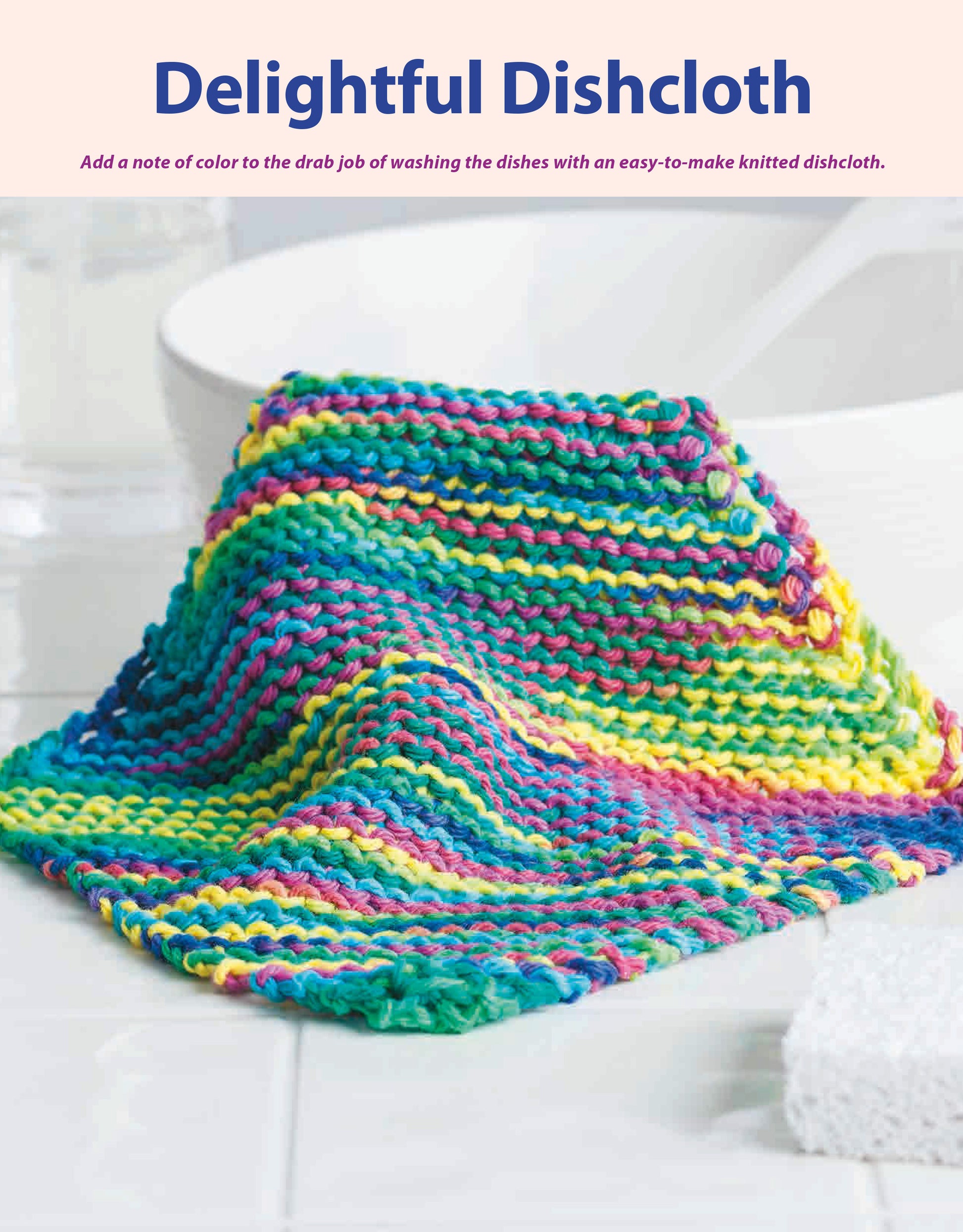 The Beginner-Friendly Knitting dishcloth by Leisure Arts features colorful hand-knitted rainbow stripes, perfect for beginners. Shown on white tiles beside a bowl, soft light highlights its vibrant texture.