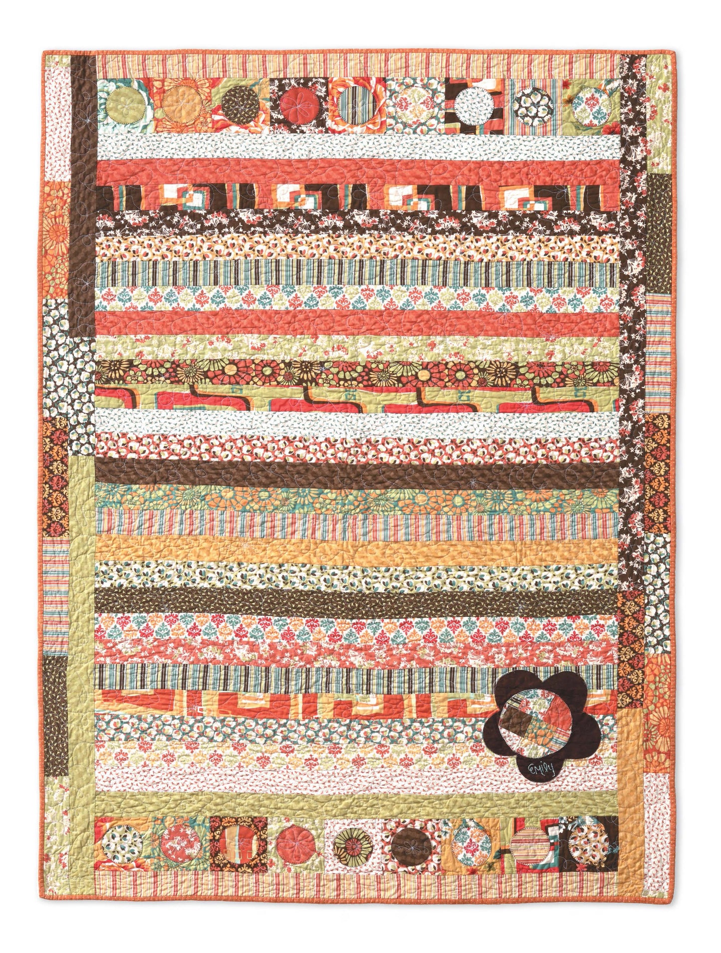 The Big Block Quilts by Leisure Arts is a colorful, handmade quilt with horizontal stripes of floral and geometric patterns, a large dark flower and abstract shapes in the lower right, plus a multicolored patchwork border.