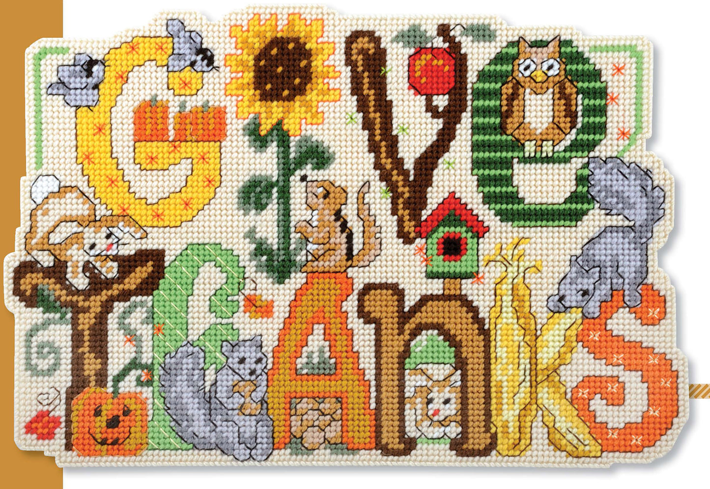 Holiday Greetings by Leisure Arts is a colorful cross-stitch pattern spelling “Give Thanks” with autumn motifs—squirrels, corn, sunflowers, pumpkins, birds, and an owl on green grass—ideal for holiday décor or as plastic canvas patterns.