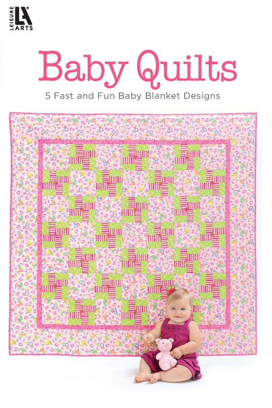 A baby sits holding a pink stuffed animal on a pink, green, and white quilt. Text above reads, Baby Quilts—Pamper Little Ones with Fast Blankets in Fun Fabrics! from Leisure Arts. 48 pages, color print. ISBN included.