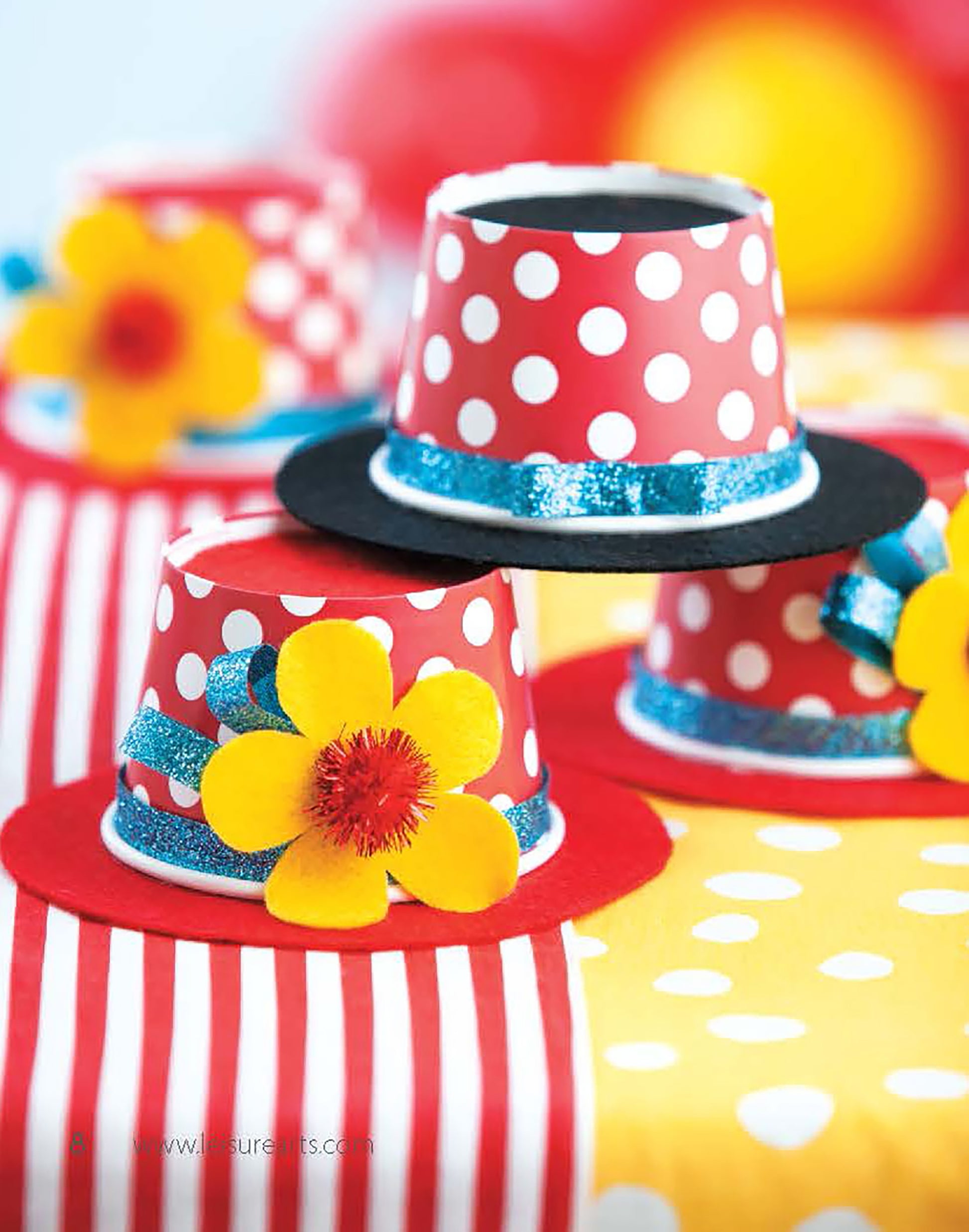 Celebrate Birthdays by Leisure Arts offers unique DIY party crafts—handmade hats from red and white polka-dotted cups, adorned with yellow felt flowers, blue glitter ribbon, and colorful brims. Perfect for themed parties and fun décor for kids or adults!.