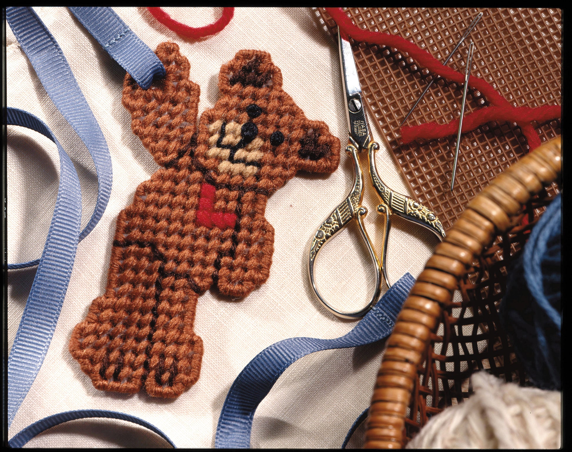 Leisure Arts' Gifts Galore in Plastic Canvas Digital Download inspires quick-and-easy crafts or unique handmade gifts, featuring project ideas surrounded by ribbons, scissors, baskets, and more craft supplies.