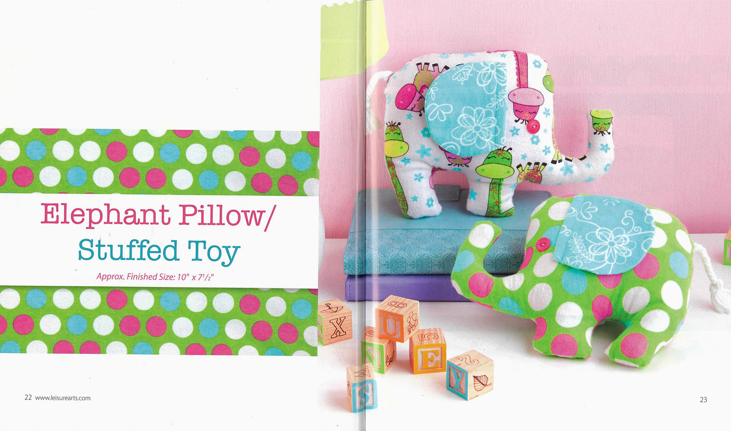 Two vibrant elephant-shaped stuffed toys made from attractive fabrics rest on a blue book titled "Simple Sewing" by Leisure Arts. The elephants, ideal for beginner sewing projects, are paired with wooden alphabet blocks in front.