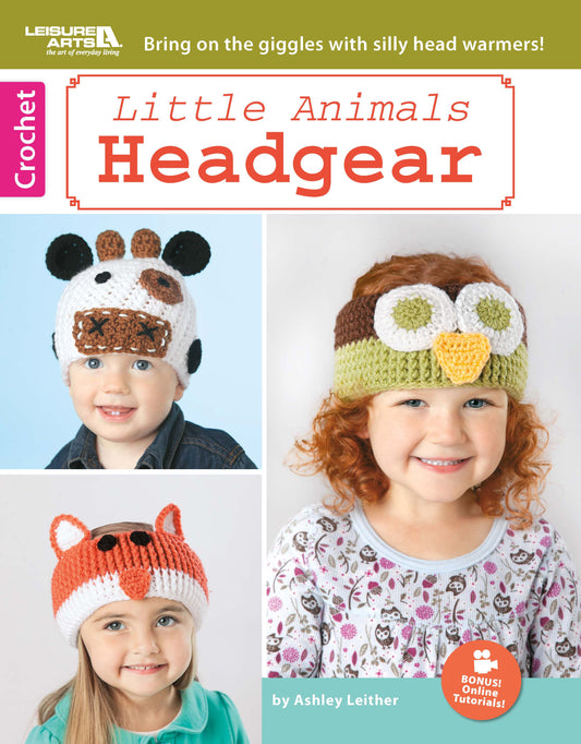 Three children wear crocheted cow, owl, and fox headbands. The "Little Animals Headgear" book by Leisure Arts features a playful cover and easy crochet patterns for adorable baby ear warmers.