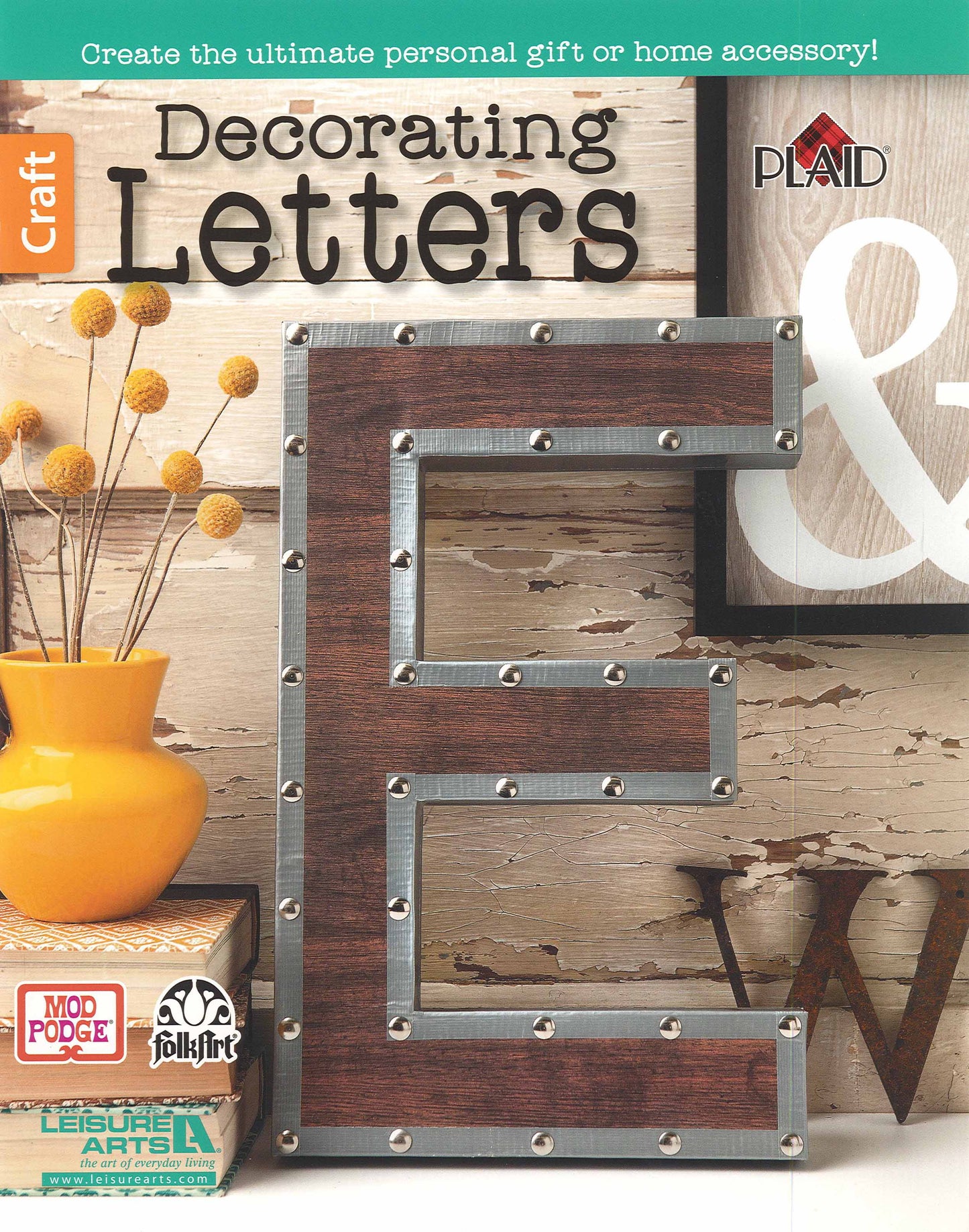 Leisure Arts' Decorating Letters Digital Download features a magazine cover with a bold metallic and wood letter E, visible bolts, Mod Podge craft supplies, vintage signs, a white ampersand, and yellow flowers on a rustic background.