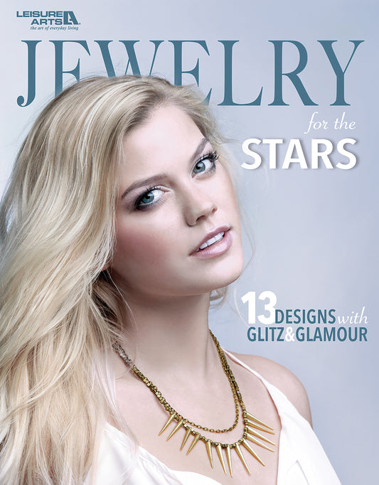 A magazine cover for Jewelry for the Stars by Leisure Arts showcases a blonde woman in a gold spike necklace. Text highlights "13 Designs with Glitz & Glamour." Find inspiration for your next statement necklace!.