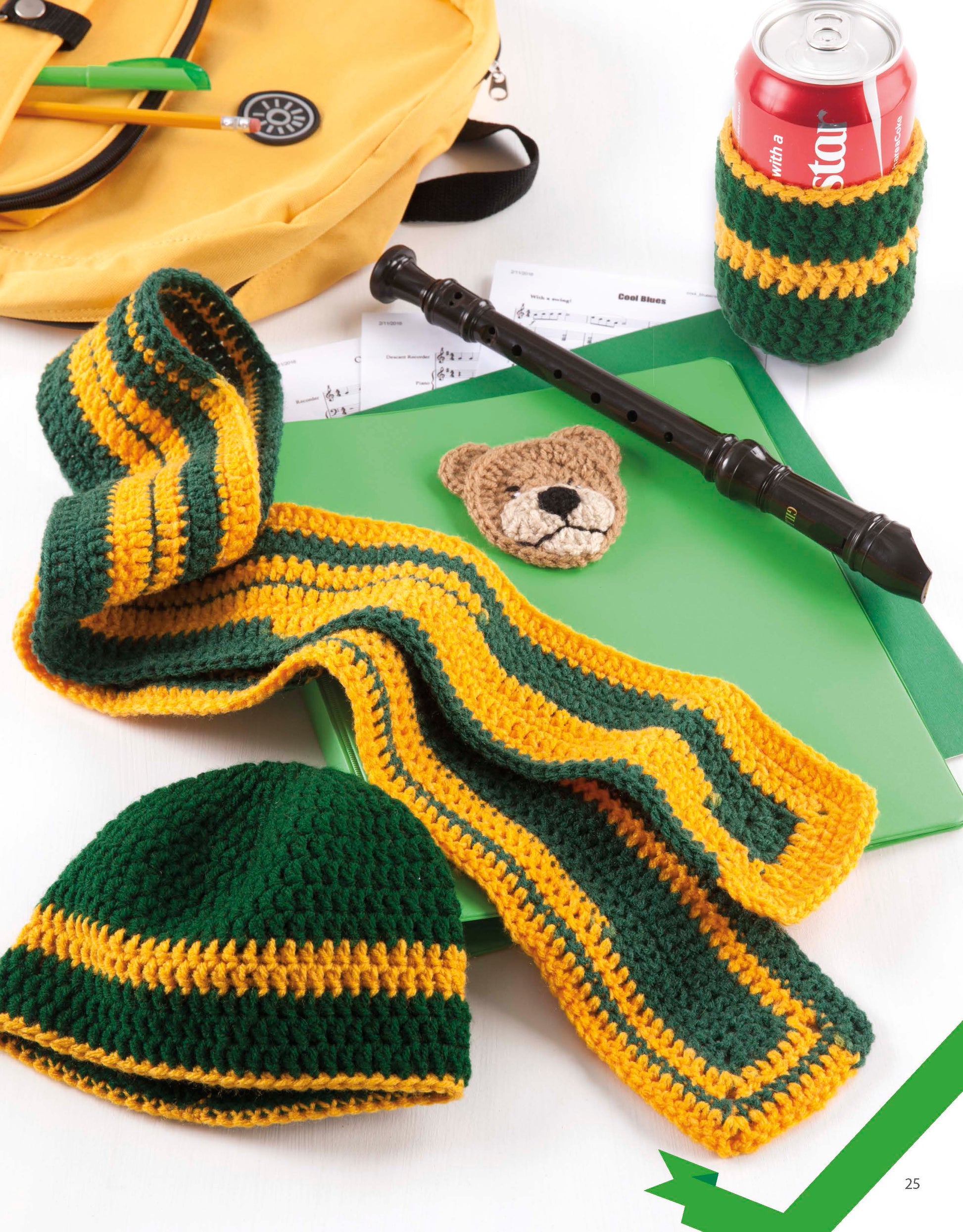 Home Team Gear by Leisure Arts: a green and yellow crocheted scarf, hat, and matching can cozy on a soda can, with music-themed accessories and a yellow backpack displayed on a white surface.