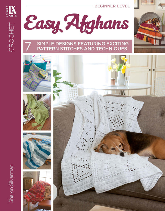 Cover of the Easy Afghans Digital Download by Leisure Arts shows a tan dog on a white crocheted afghan, with smaller images of easy crochet blankets—ideal for beginners looking for simple patterns.