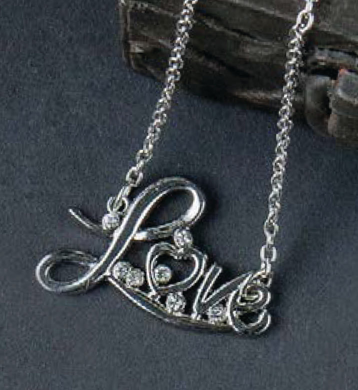 The “Wanderlust—Travel-Inspired Jewelry” silver necklace by Leisure Arts features a pendant that spells “Love” in elegant cursive, adorned with sparkling clear gemstones and displayed on a dark surface—making it an ideal versatile accessory for mix-and-match jewelry looks or as stylish travel jewelry.