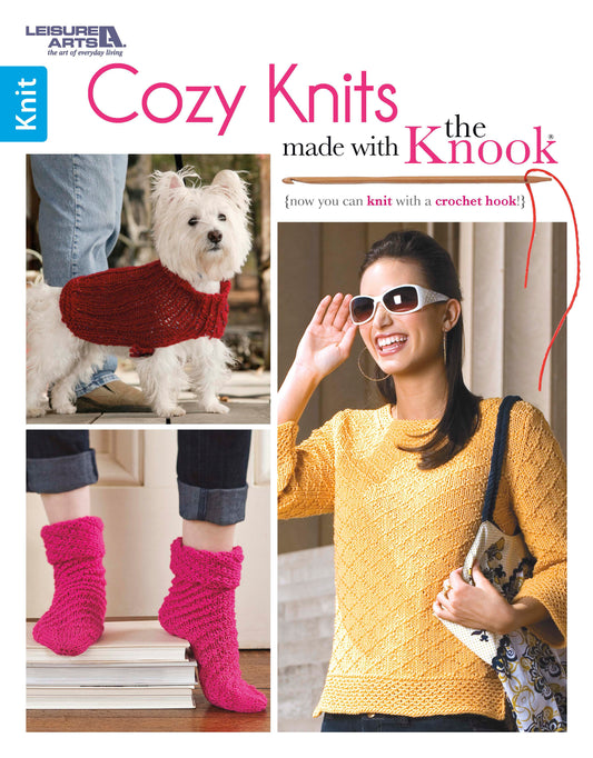 The book cover for "Cozy Knits Made with the Knook" by Leisure Arts shows a dog in a red sweater, a woman in a yellow top, and bright pink socks—ideal for anyone wanting to knit with a crochet hook using easy instructions.