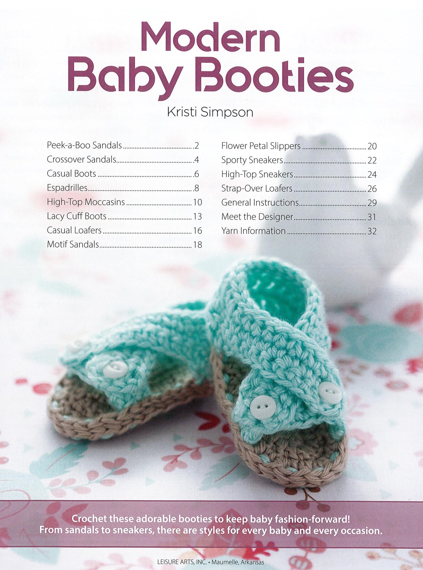A pair of mint green and beige crocheted baby booties sits on a white surface with a blue polka dot cloth below. Text above highlights beginner crochet patterns from the Modern Baby Booties Digital Download by Leisure Arts.