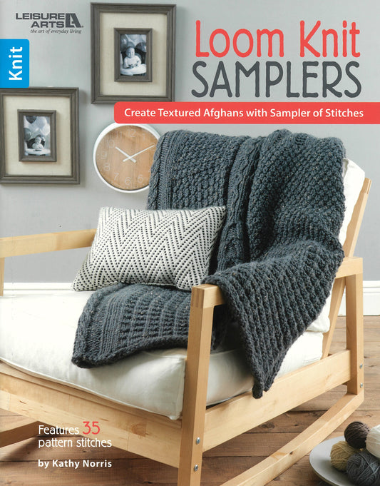 Cover of Loom Knit Samplers by Leisure Arts, showing a gray textured knit blanket with intricate stitch patterns draped over a wooden chair and patterned pillow, with framed art in the background.