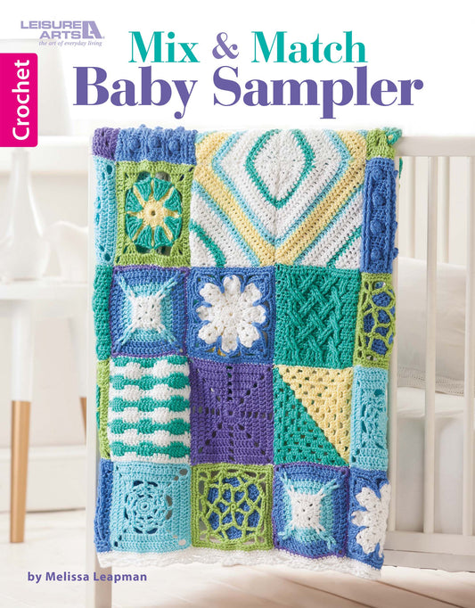 A vibrant crocheted baby blanket with textured granny squares in blue, green, yellow, white, and teal drapes over a crib rail. Mix & Match Baby Sampler by Leisure Arts is perfect for creating unique crochet blankets.