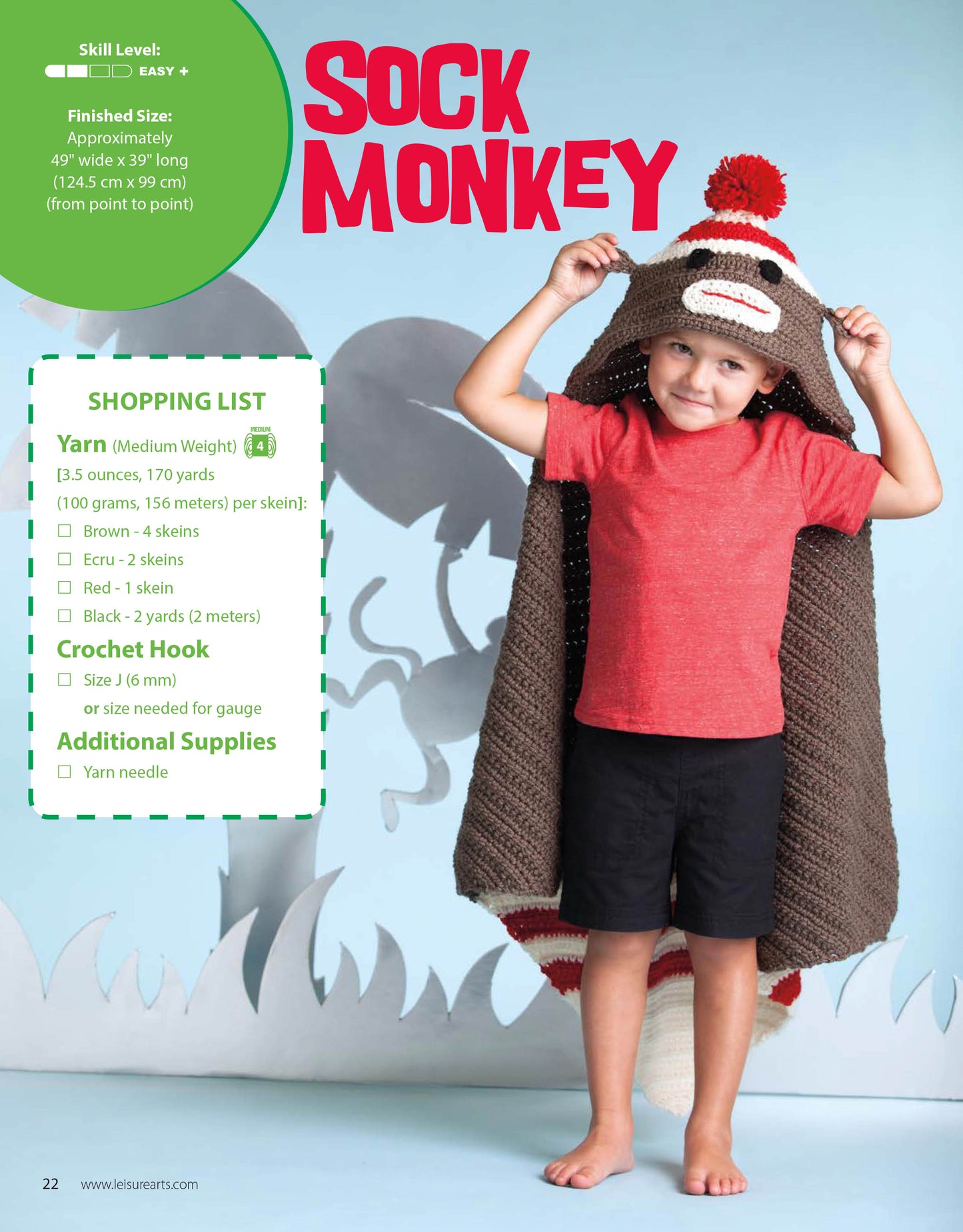 A young boy smiles inside a Leisure Arts Crochet Animal Blanket, made with medium weight yarn and playful appliqué. Cartoon jungle plants decorate the background, while text provides project details and a shopping list.