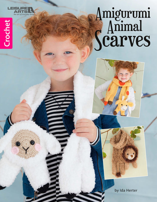 A smiling girl with curly red hair wears a fluffy white scarf featuring a crocheted lamb. Inset images display her modeling adorable animal scarves—a yellow giraffe and brown lion. Text reads "Amigurumi Animal Scarves" by Leisure Arts.
