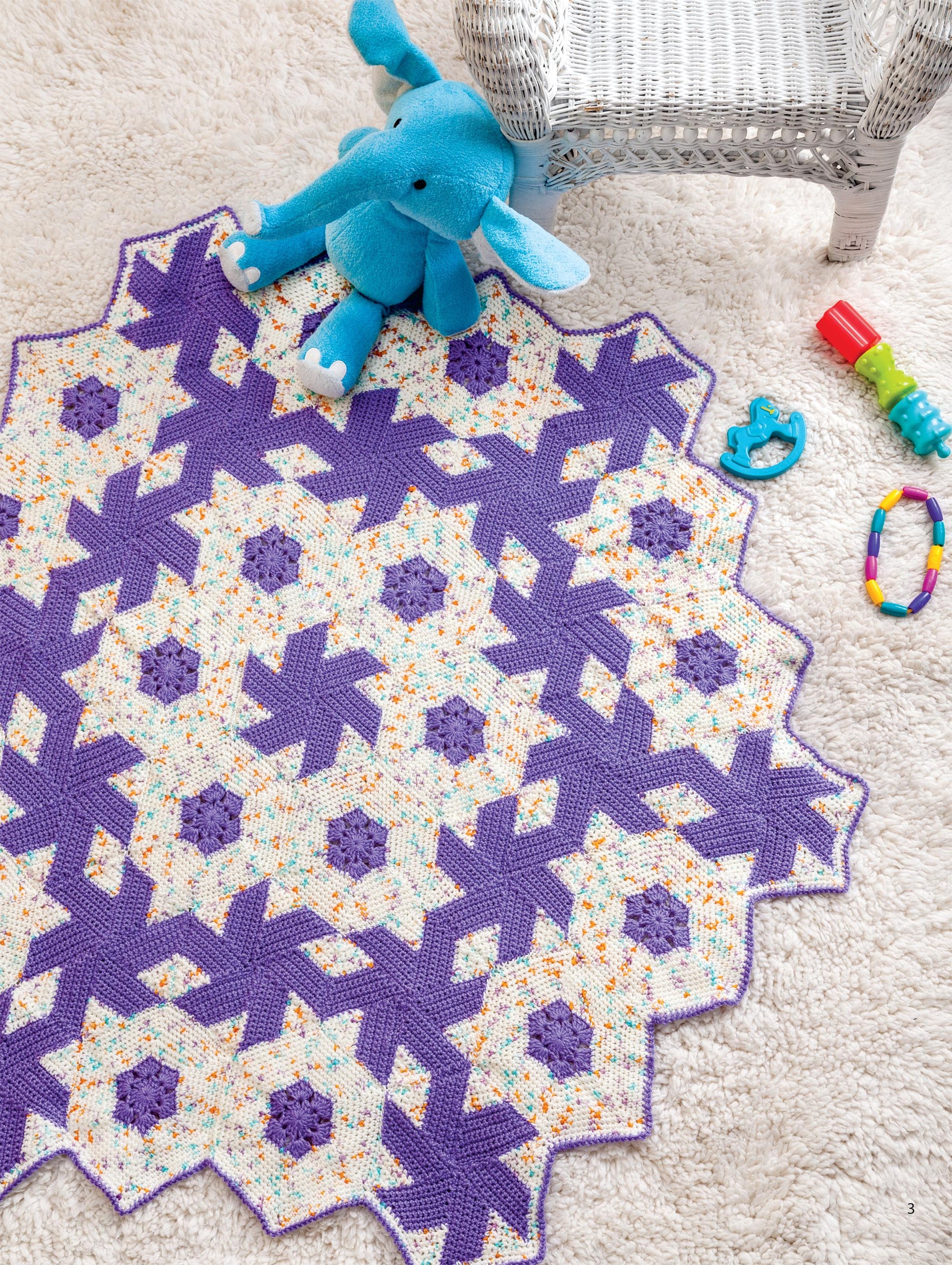The "Hooked On Quilted Crochet" digital download by Leisure Arts features charming nursery decor ideas, like a purple and white baby quilt paired with playful toys—a perfect inspiration for your little one's space.