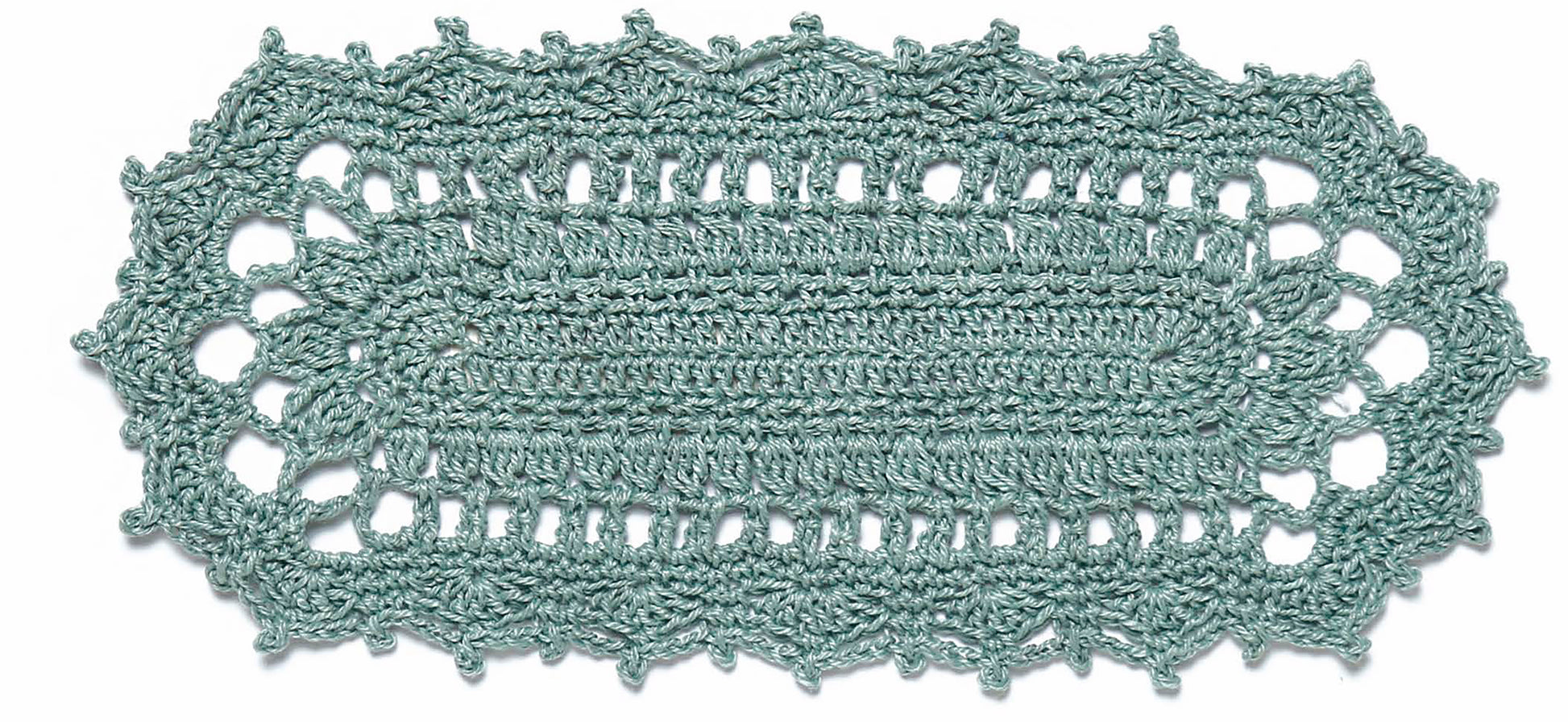 Add charm to your home with Doilies Updated by Leisure Arts—a light blue-green oval doily featuring a tightly woven center and intricate lacy scalloped border, perfect for any crochet decor collection.