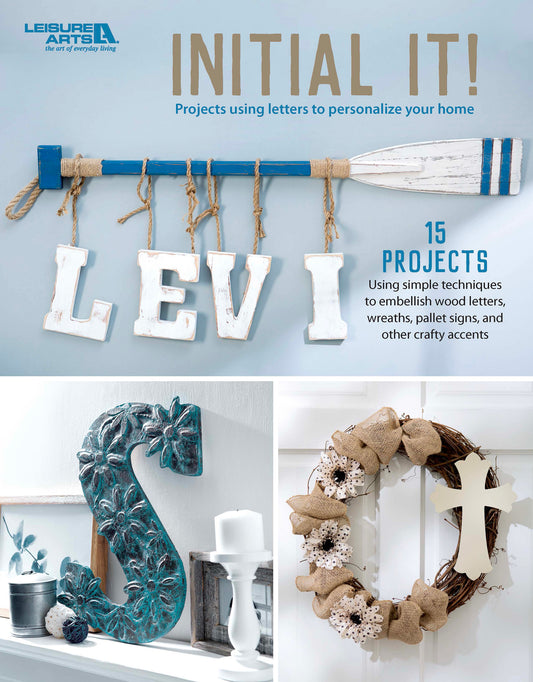 Book cover for Initial It!—15 Projects using simple techniques to embellish wood letters, wreaths, pallet signs, and other crafty accents by Leisure Arts, featuring the title “INITIAL IT!” alongside creative letter crafts, such as “LEVI” on a paddle, a teal “S” displayed on a shelf, and a wreath embellished with a cross. Highlights 15 inspiring projects designed to help you personalize wood letters with ease—ideal for anyone who loves crafting pallet signs or adding custom touches to their home décor.