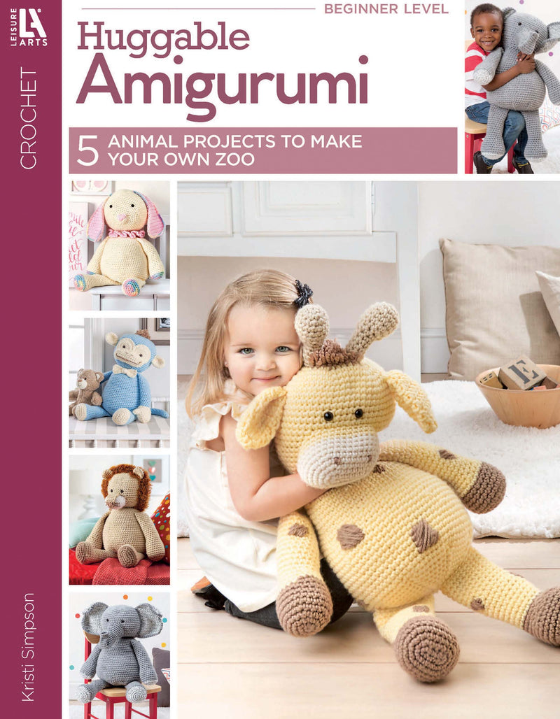 The cover of "Huggable Amigurumi" by Leisure Arts shows a smiling girl holding a crocheted giraffe, with crocheted lion, elephant, rabbit, and bear toys made using super bulky yarn also displayed.