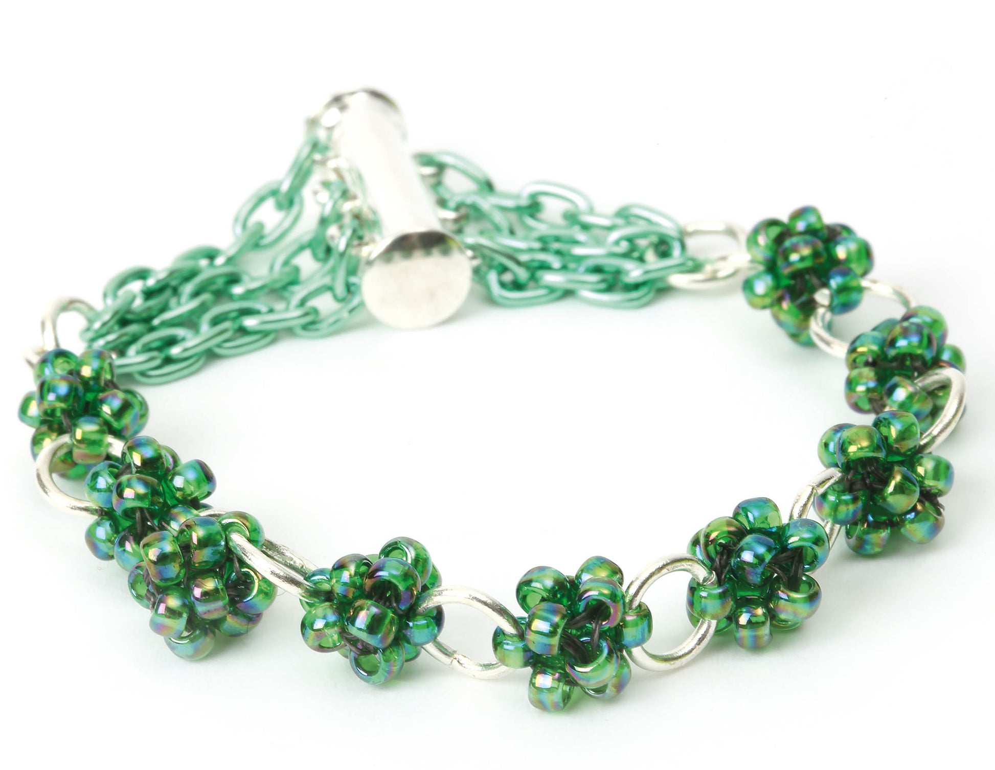 Perfect for beginner jewelry projects, Leisure Arts’ Quick & Simple Jewelry Beading for Beginners features green and blue beaded flower clusters linked by silver rings, a green chain, and a silver toggle clasp.