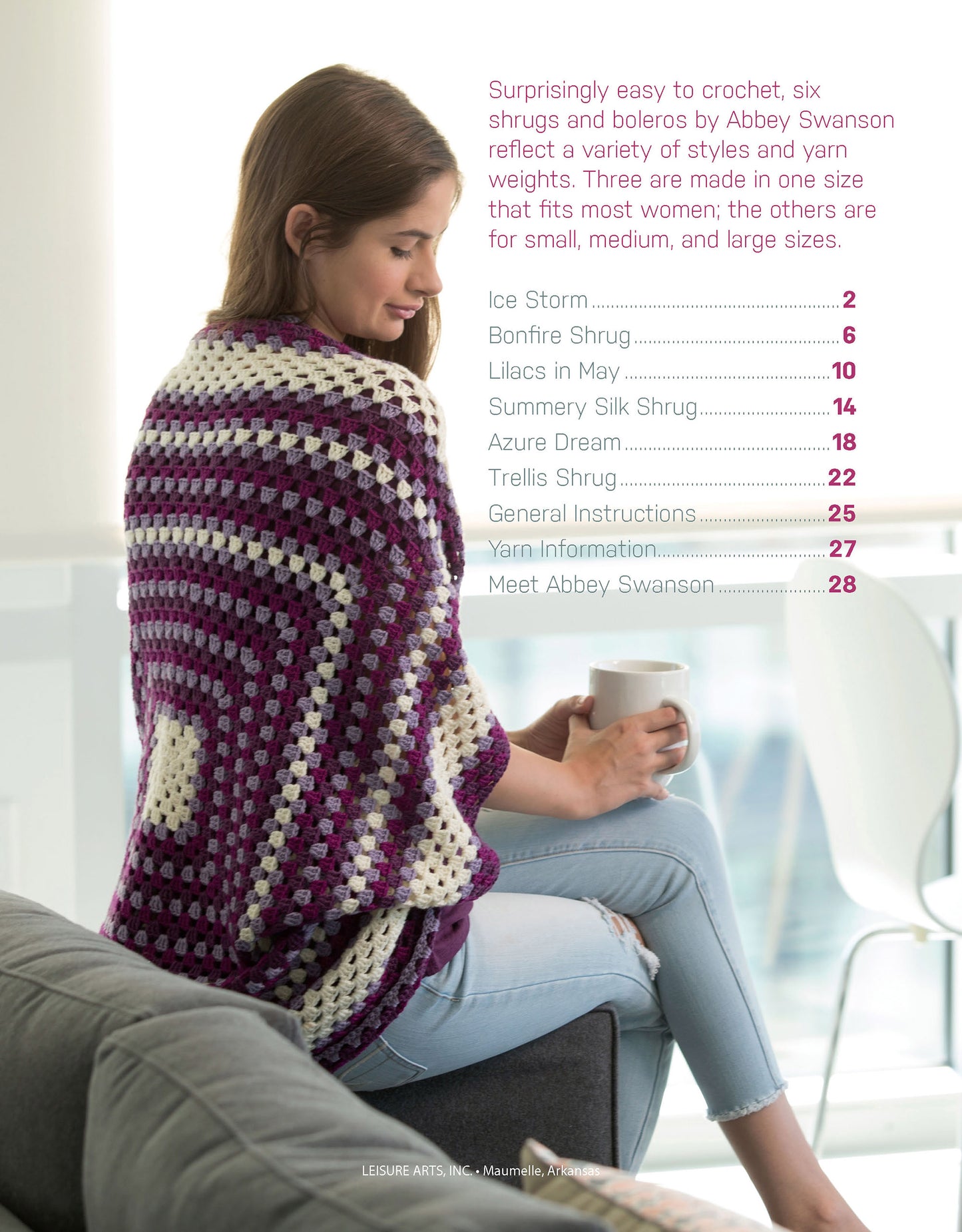 A woman sits on a gray sofa, wearing a purple and white shrug as she holds a white mug. She smiles as the Leisure Arts "Crochet Shrugs & Boleros" table of contents featuring beginner designs appears beside her.