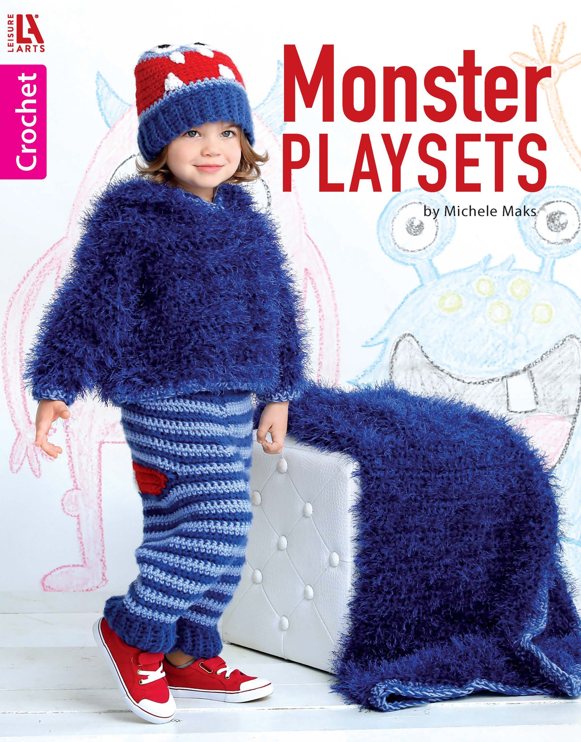 A young child models a cozy blue monster crochet hoodie and striped pants from Leisure Arts' Monster Playsets, standing beside playful blankets with cartoon monsters. Text reads “Monster Playsets.”.