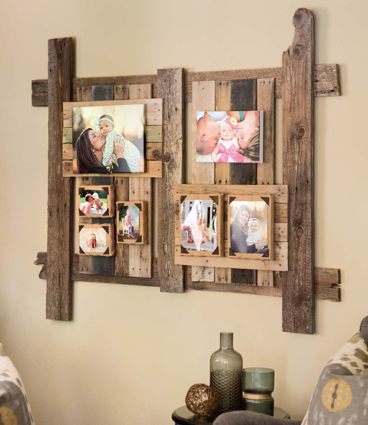 Do-It-Yourself Pallet Projects by Leisure Arts inspires this rustic photo collage frame, repurposed from wood pallets and displayed with family photos above decorative vases, all flanked by two patterned chairs.