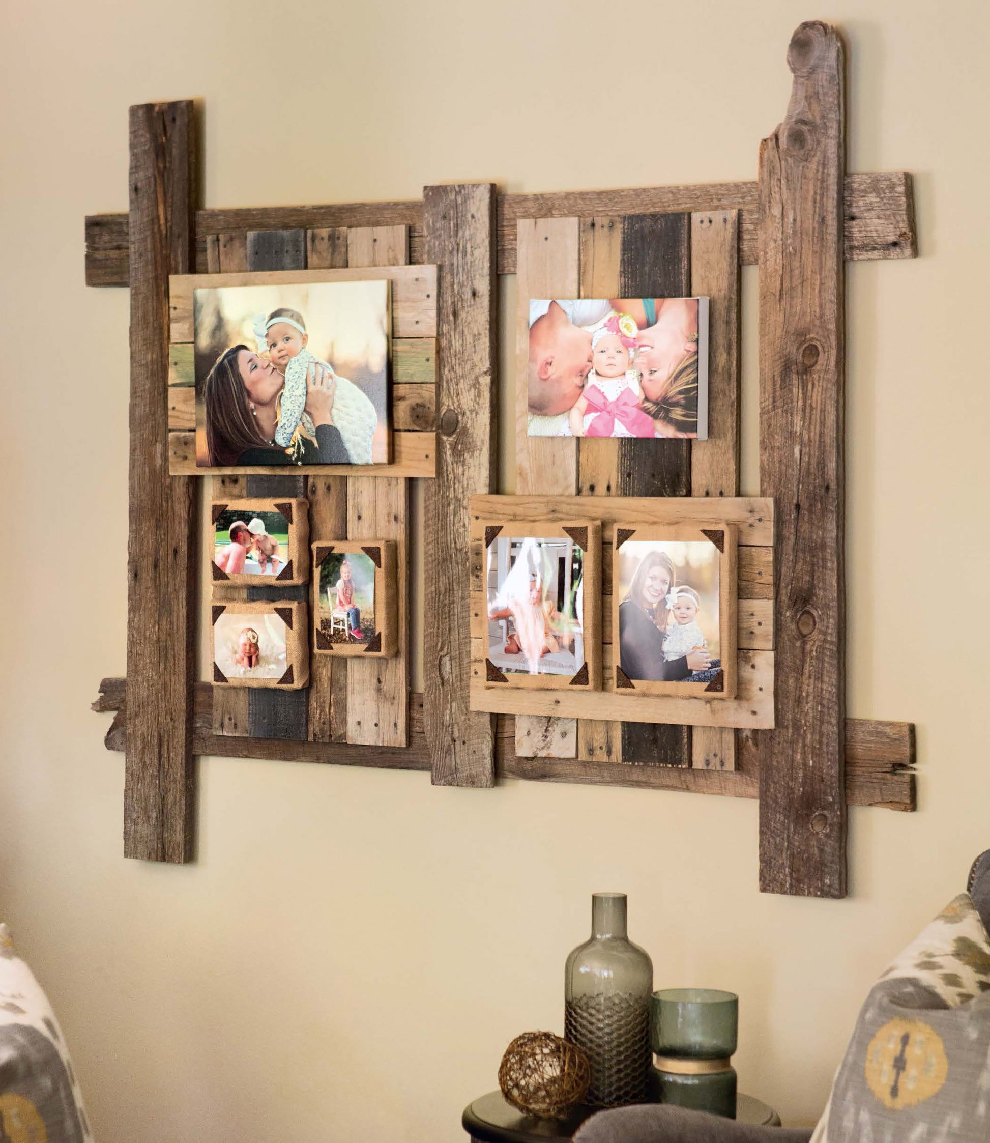 Do-It-Yourself Pallet Projects by Leisure Arts inspires this rustic photo collage frame, repurposed from wood pallets and displayed with family photos above decorative vases, all flanked by two patterned chairs.