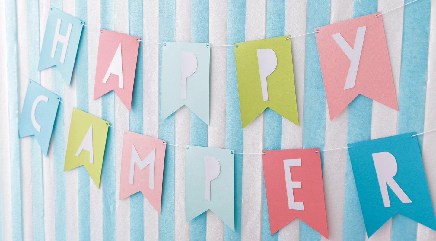 Create festive décor with pastel pink, blue, and green paper flags that spell “HAPPY CAMPER.” From Leisure Arts’ Paper Party—Easy-to-Make Projects for Parties, Celebrations & Even Home Decor. Perfect for parties or crafting fun!.