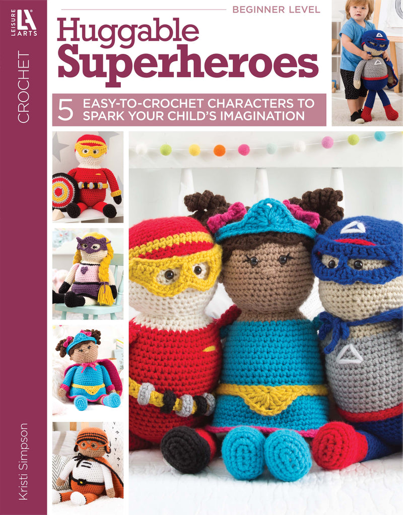 The cover of Leisure Arts' Huggable Superheroes shows three crocheted superhero dolls sitting together, with smaller images of additional crochet superhero patterns displayed along the left side.