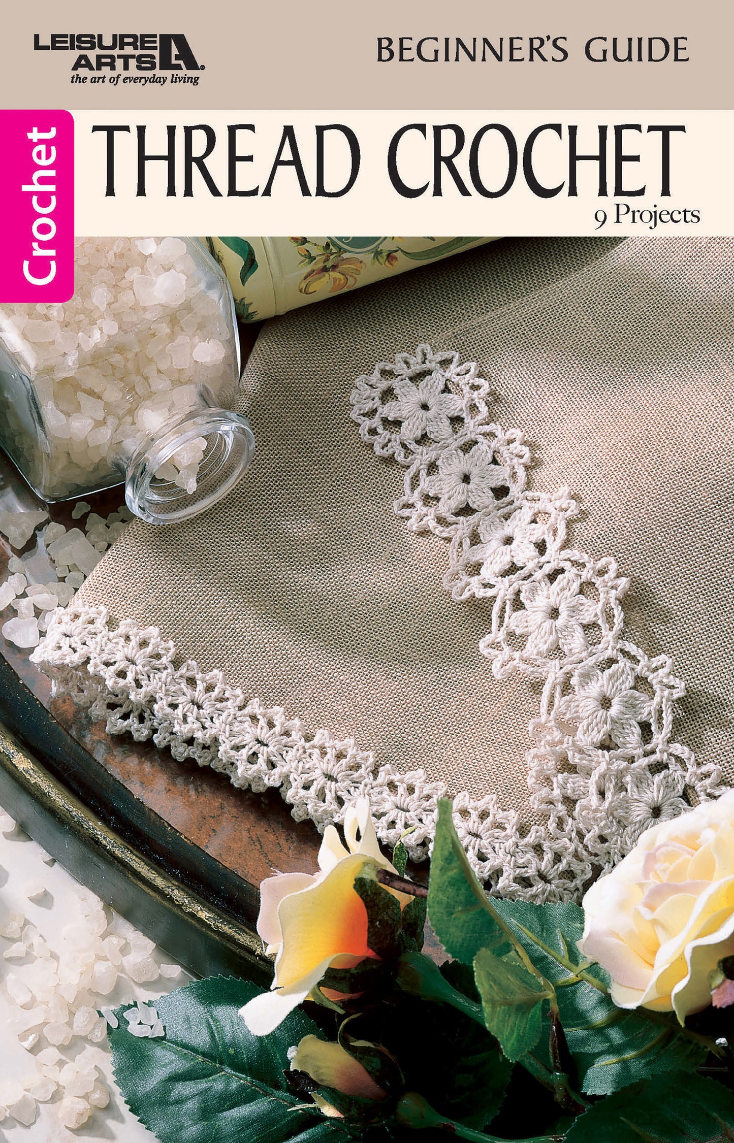 Leisure Arts’ Thread Crochet—A Beginner's Guide to 9 Projects Digital Download features a brown crochet book cover with delicate lace edging, plus a jar of white beads and a yellow flower. Perfect for beginners seeking beautiful results.