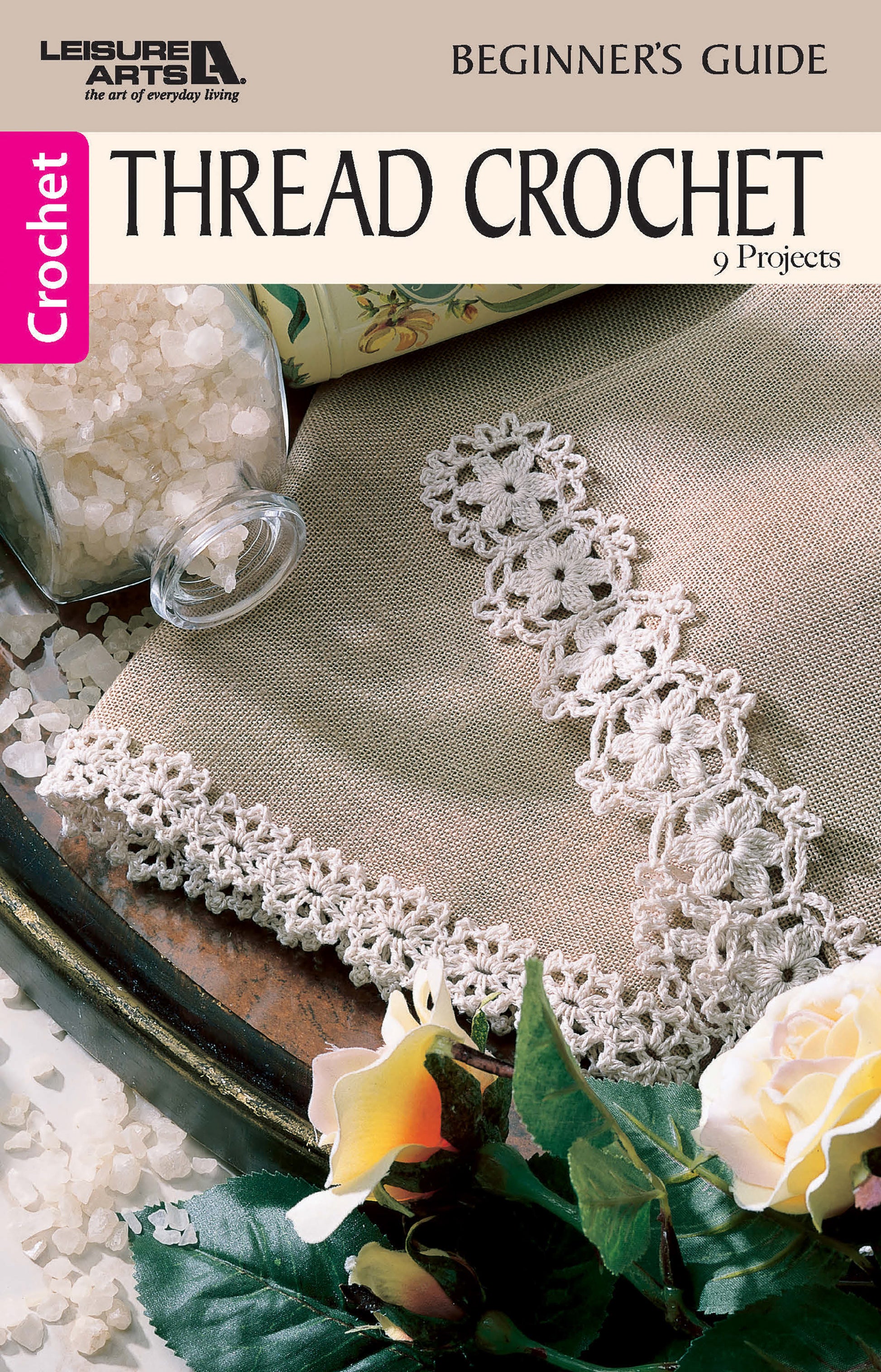 Leisure Arts’ Thread Crochet—A Beginner's Guide to 9 Projects Digital Download features a brown crochet book cover with delicate lace edging, plus a jar of white beads and a yellow flower. Perfect for beginners seeking beautiful results.