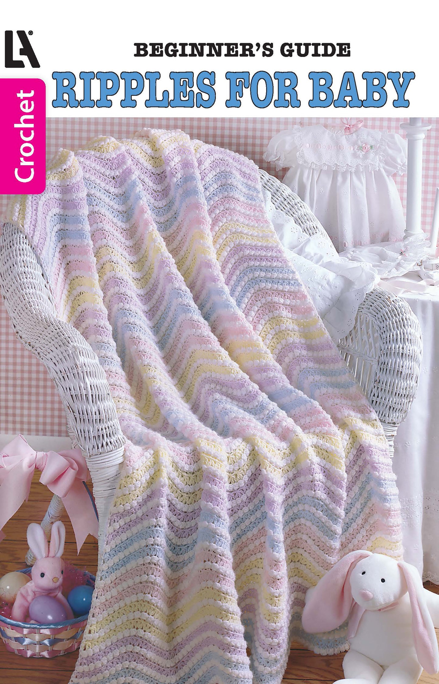 Leisure Arts’ Ripples for Baby to Crochet: a pastel ripple-pattern baby blanket, ideal for beginner ripple afghan designs, draped on a white wicker chair with a plush bunny and Easter basket in a cozy nursery.