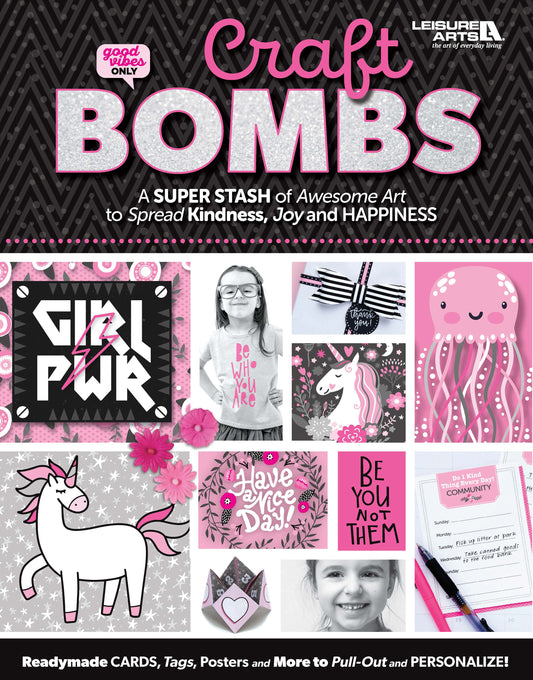 The Leisure Arts Craft Bombs activity book features a vibrant cover with unicorn, octopus, smiling girl, motivational quotes, and craft supplies. Includes cards, tags, posters to pull out and personalize—promoting kindness, joy, happiness, and kids’ creativity.
