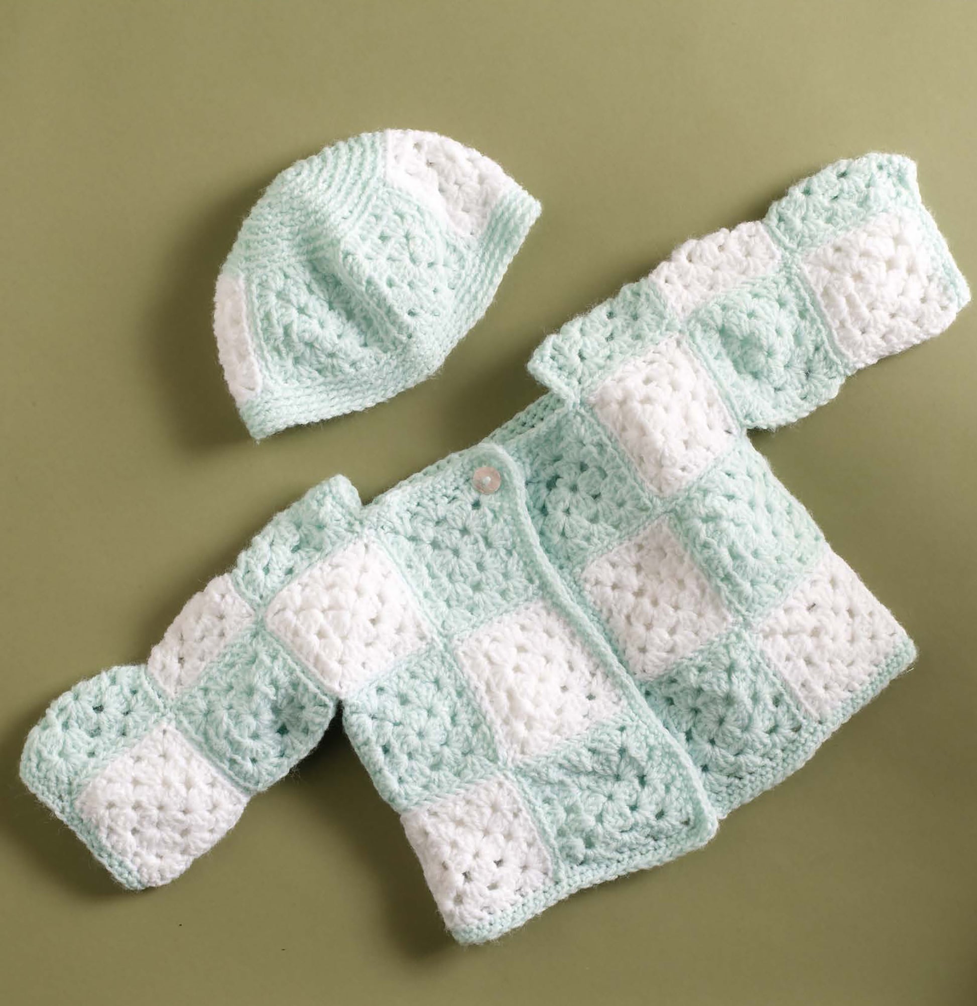 Small Comforts—4 Crochet & 2 Knit Designs Created with Lion Brand Babysoft by Leisure Arts features adorable pastel green and white baby jacket and hat patterns, perfect for anyone seeking charming baby crochet projects.