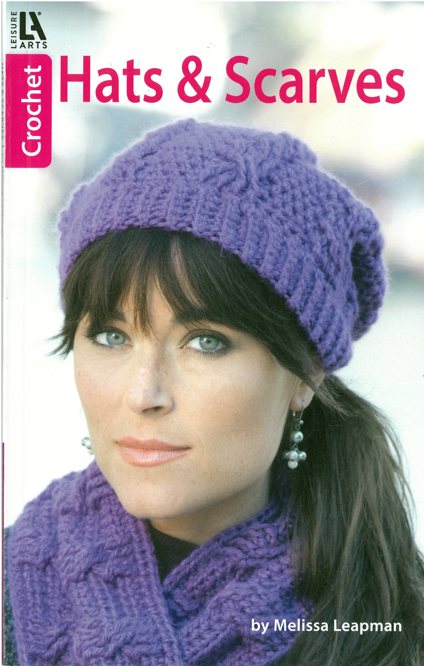 A woman models a matching purple crocheted hat and scarf, highlighting stylish Hats & Scarves from Leisure Arts. The cover displays the text "Hats & Scarves by Leisure Arts.