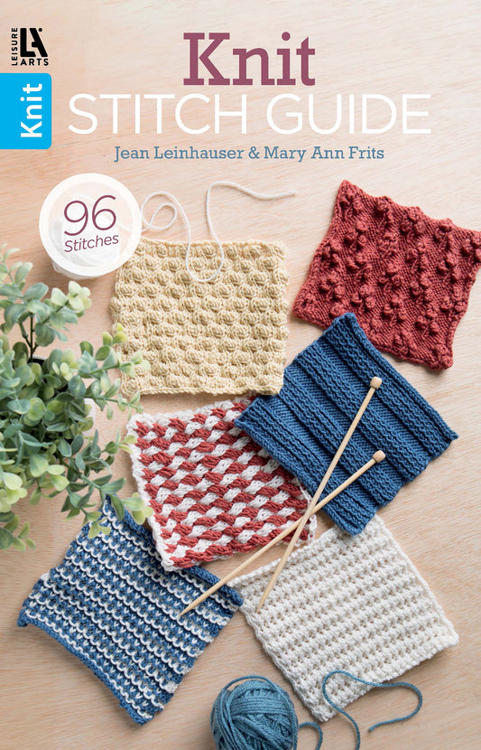 Five colorful knitted swatches with unique patterns are arranged on a light wood surface. The cover reads “Knit Stitch Guide” by Leisure Arts, featuring 96 stitch designs for all skill levels.