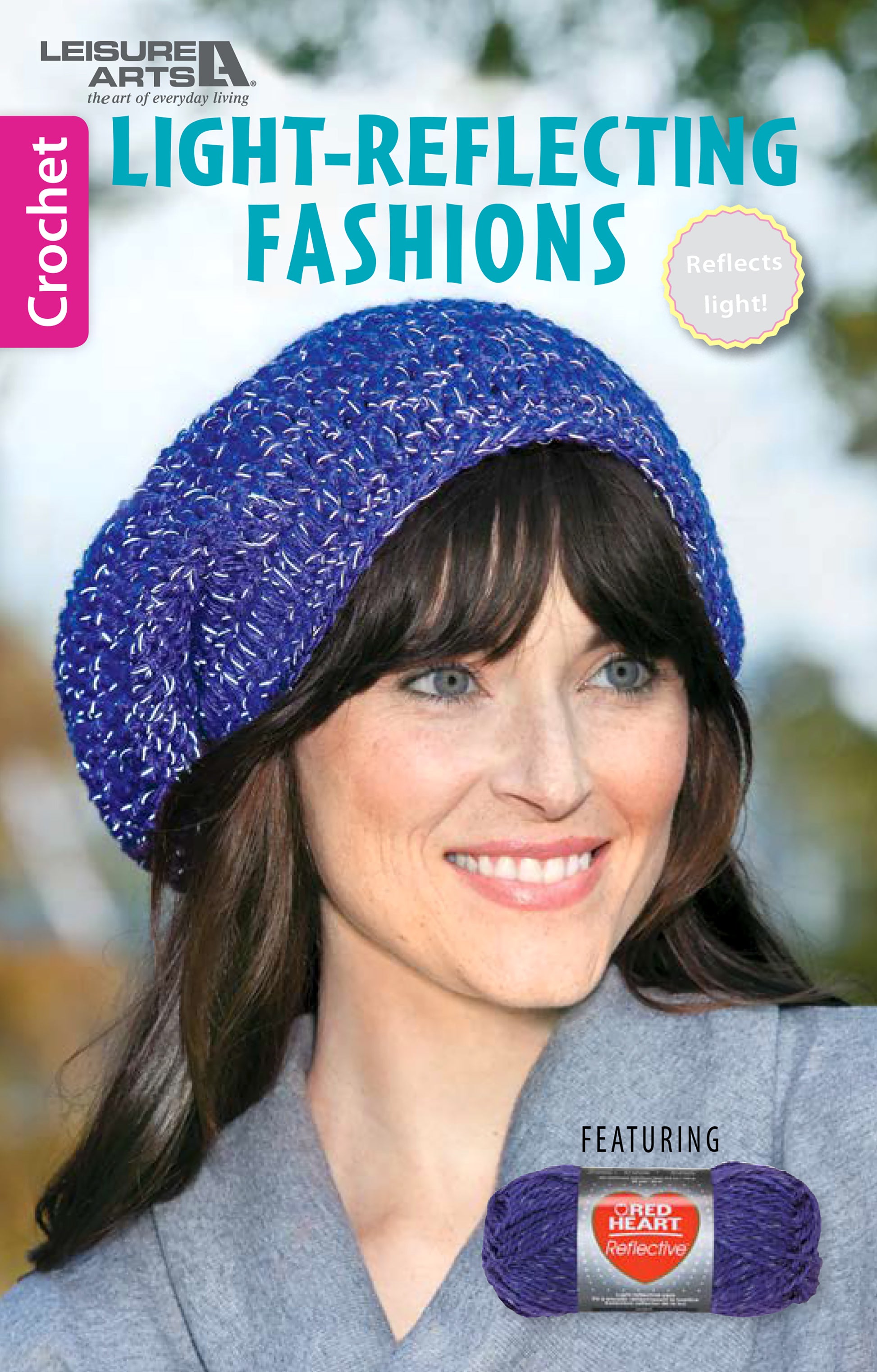 A woman outdoors smiles in a shiny purple crocheted beret. The cover of Leisure Arts' Light-Reflecting Fashions spotlights projects using reflective yarn, such as scarves and totes, with a skein of reflective yarn visible in the corner.