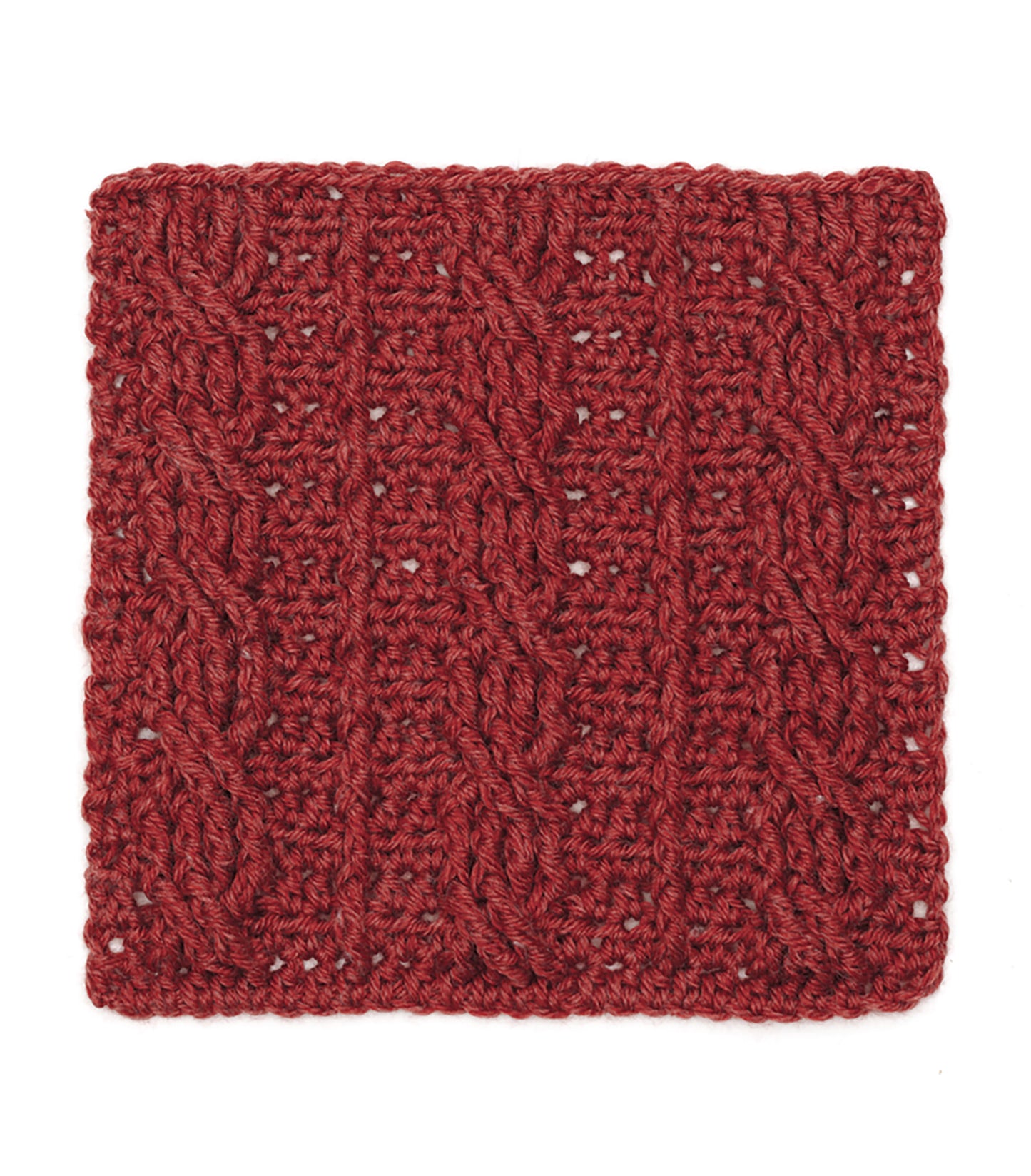 A deep red knitted swatch with vertical cables and twists is laid flat on white—perfect inspiration for your next sampler afghan, just like the patterns in the Granny Square Stitch Guide from Leisure Arts.