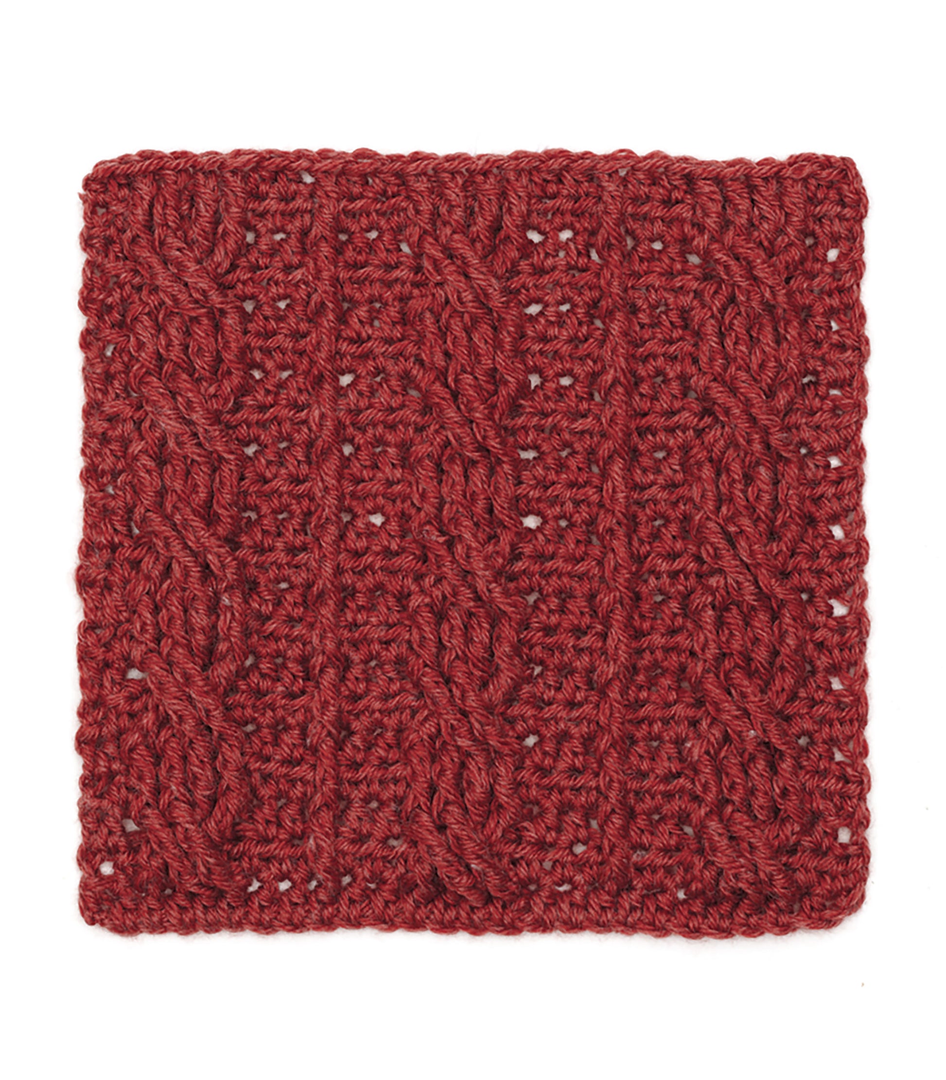 A deep red knitted swatch with vertical cables and twists is laid flat on white—perfect inspiration for your next sampler afghan, just like the patterns in the Granny Square Stitch Guide from Leisure Arts.