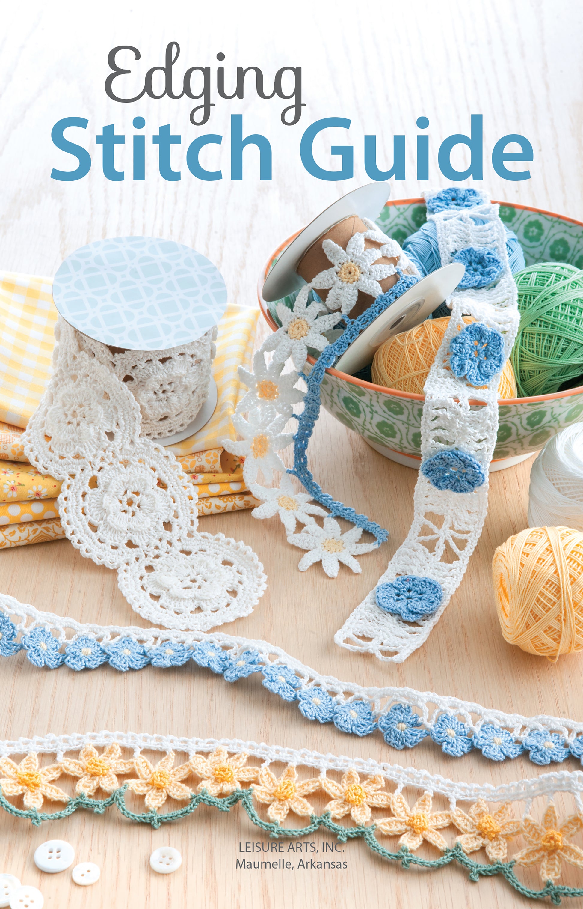 Book cover for Edging Stitch Guide by Leisure Arts featuring crochet edgings and lace trims with floral motifs in blue, white, and yellow, displayed alongside yarn balls and fabric on a wooden surface.