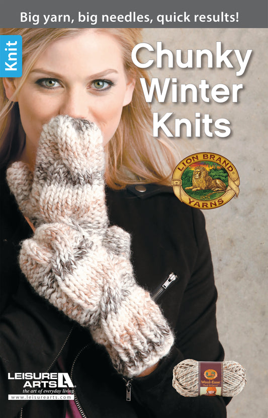 A blonde woman wears a thick, light gray and brown knit sweater and matching mittens made from super bulky yarn, covering part of her face. The text reads Chunky Winter Knits by Leisure Arts.
