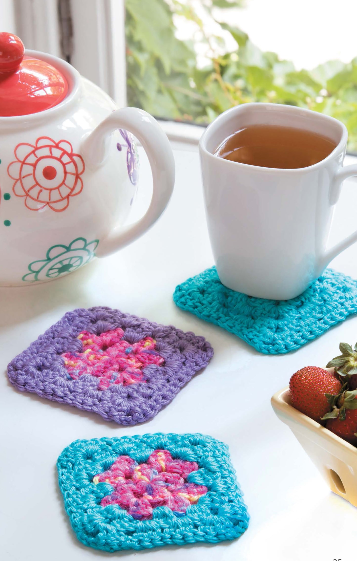 Leisure Arts Mug Hugs & Coaster Sets: Colorful crocheted teal and purple coasters with pink floral centers, perfect for brightening any table—pairs beautifully with your mug of tea and favorite teapot.
