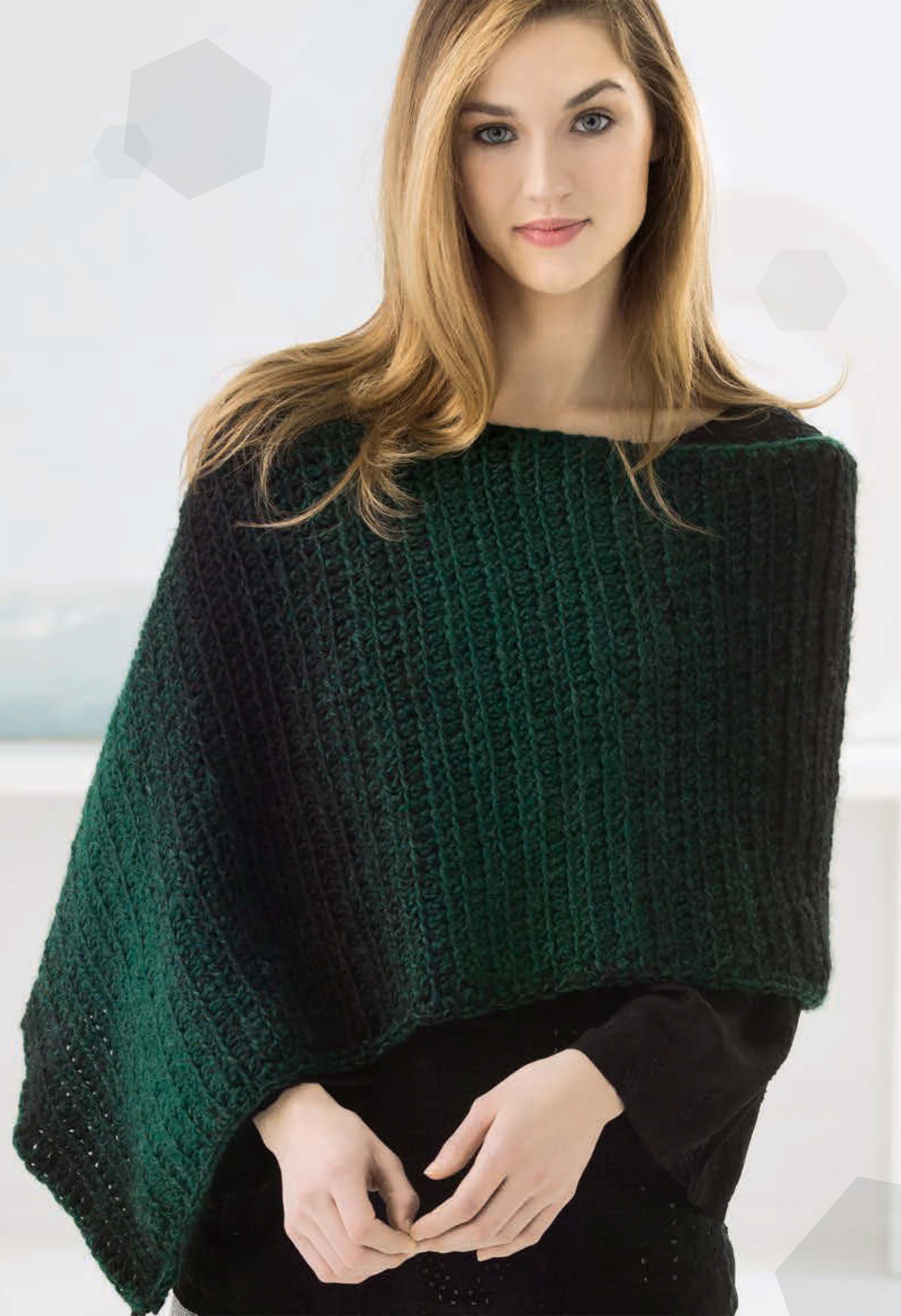 A woman with long, straight hair wears a dark green, ribbed knit poncho over a black top against a softly blurred background—perfect inspiration for crochet projects like Simply Scarfie Crochet by Leisure Arts.