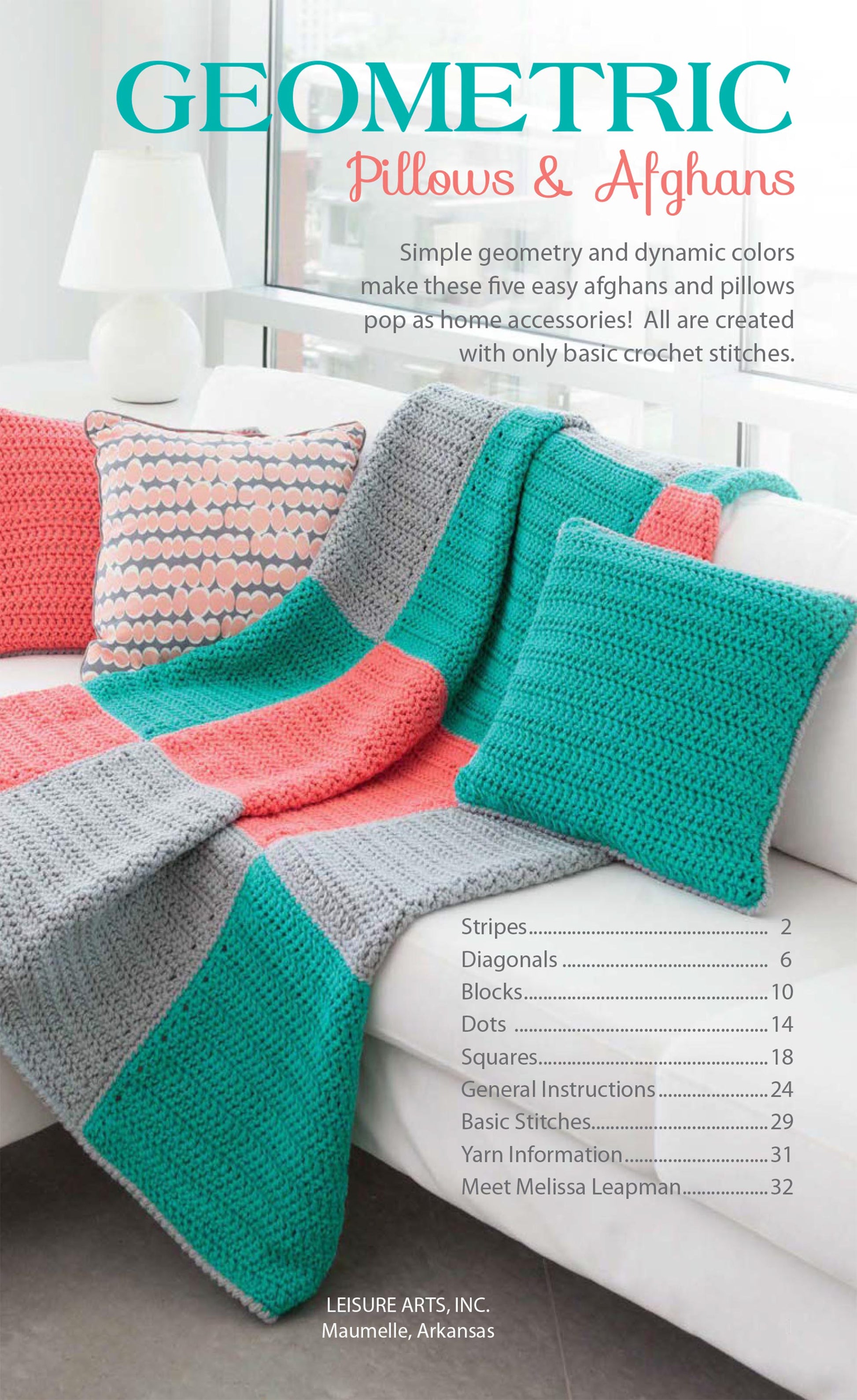A modern living room with a white couch displays coral, teal, and gray crochet accents made using beginner patterns from the "Geometric Pillows & Afghans" book by Leisure Arts.