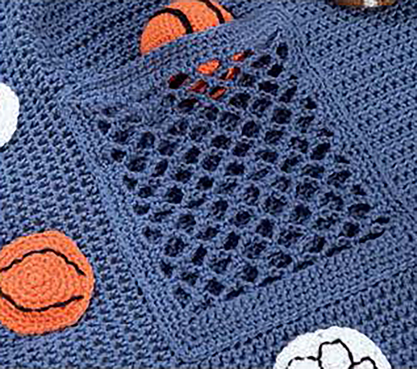 A close-up of the Baby Collection—by Leisure Arts shows a blue crochet blanket with a mesh pocket and orange and white basketball motifs, perfect for baby projects or beginner crochet patterns.